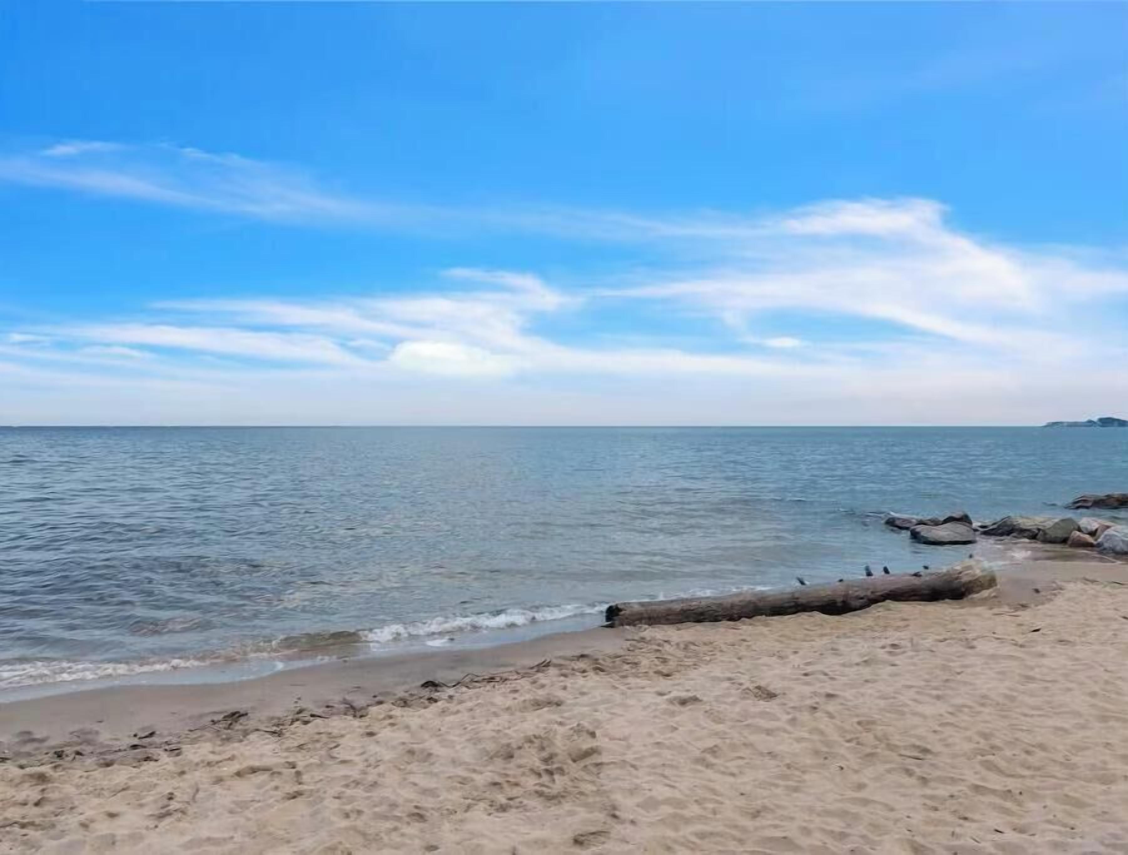 A beach with clear skies and calm water.