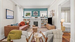 A living room with a fireplace, a sofa, a coffee table, and a television.