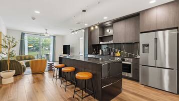 2 Bedroom Deluxe Suite w/ Balcony | Private kitchen | Fridge, microwave, oven, stovetop