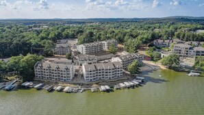 A waterfront hotel with multiple buildings, a dock with boats, and a surrounding forested area. - Jana`s Penthouse, Fireplace, Skiing, Boating (Wisconsin Dells)