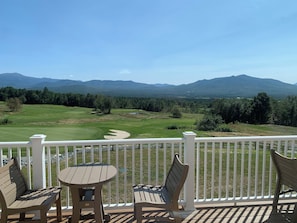 A balcony with a view of a golf course and mountains. - Spacious retreat with Stunning views of Mount Washington!! 3Bedroom + 2Bath (Bartlett)
