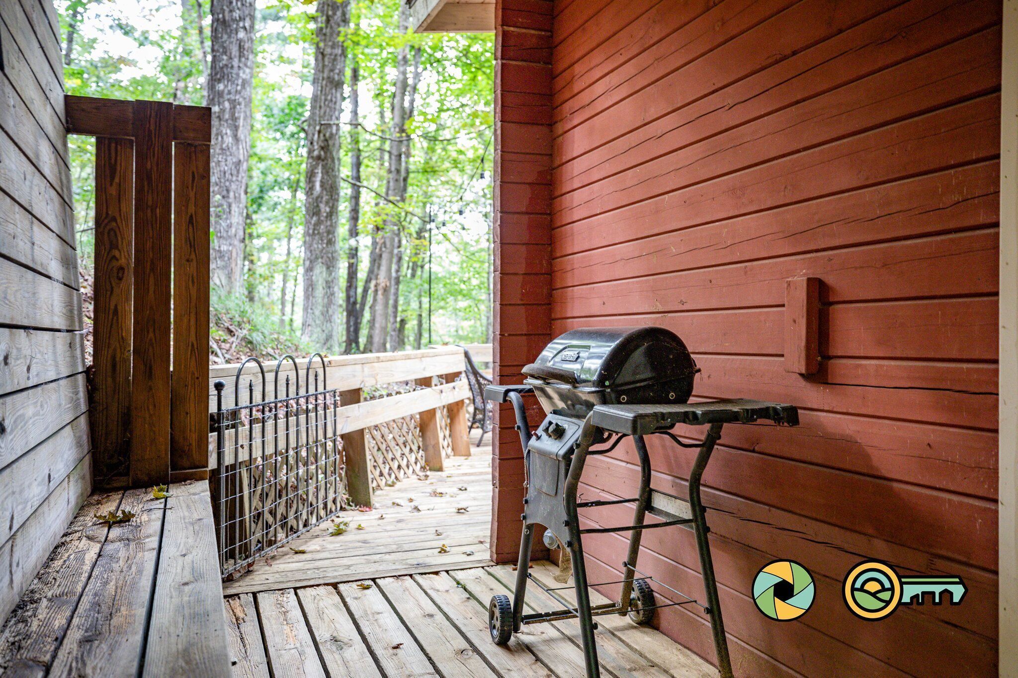 A wooden deck with a grill and a bench.