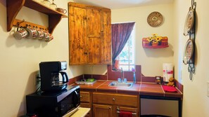 Fridge, microwave, coffee/tea maker, cookware/dishes/utensils