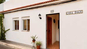 A white building with a tiled roof, a wooden door, and a sign reading 'CASA DACE.' - CASA DACE Authentic West-Coast Stay (El Albercon)