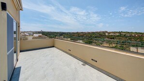 A rooftop terrace with a clear view of a cityscape. - Stylish Gozo Penthouse Spacious and Quiet Terrace (Nadur)