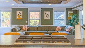 A kitchen with a central island, built-in cabinets, and a large overhead range hood. - 
Spacious 5-Bedroom Retreat Minutes from Washington (Virginia)