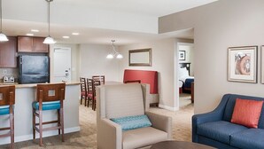 A modern living room with a kitchen area, a dining set, and a ceiling fan. - Club Wyndham National Harbor (Oxon Hill)