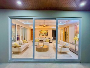 A modern living room with a sofa, chairs, a coffee table, and a dining area with a table and chairs. - 6k Sq Ft of Luxury Mountain View’s over the Pacific Ocean in SJDS! (San Juan Del Sur)
