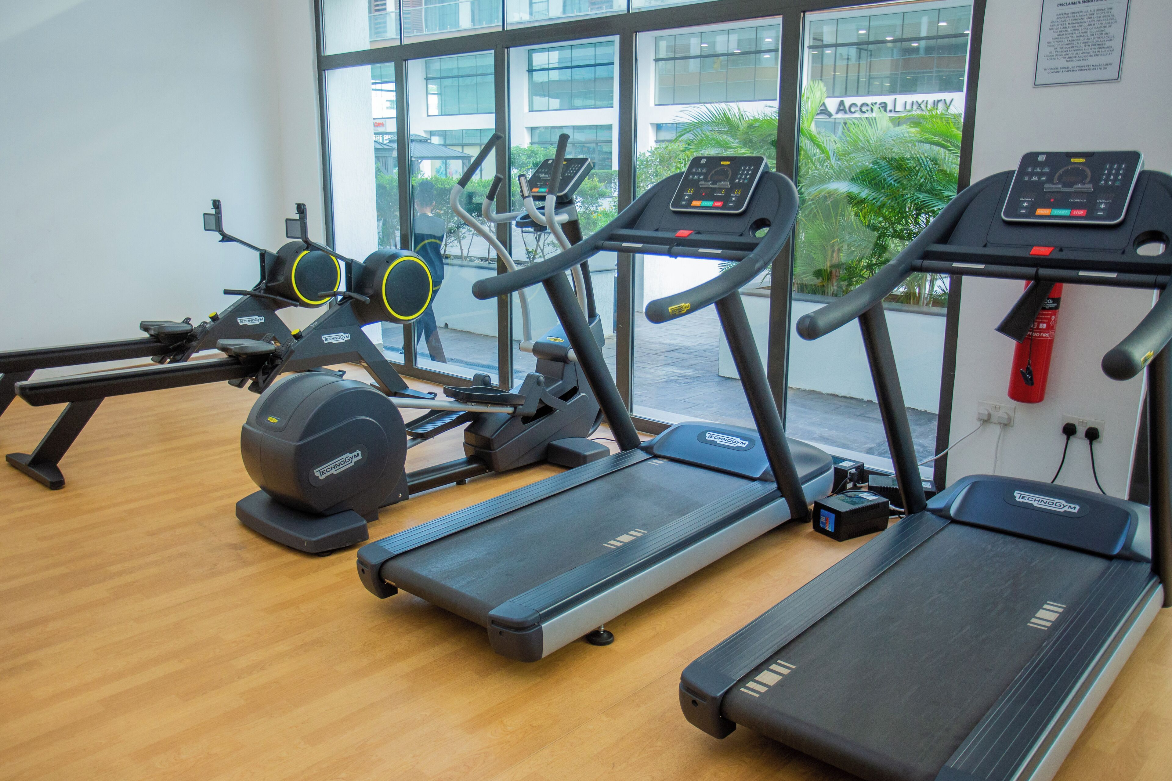 A gym with treadmills, ellipticals, and a stationary bike.