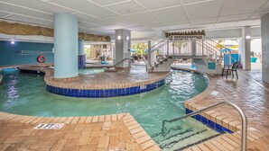 An indoor swimming pool with a 3 FT depth marker, a staircase, and a covered seating area. - Oceanfront One-Bedroom Condo with Stunning Paradise Views (Myrtle Beach)
