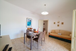 Een knus woongedeelte met een eethoek, een bank en een kitchenette.