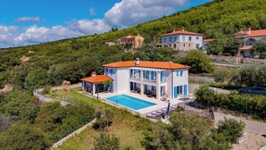 A villa with a swimming pool, surrounded by lush greenery and hills. - Villa Luka with Private Pool & Sea View, Labin, Croatia (Labin)