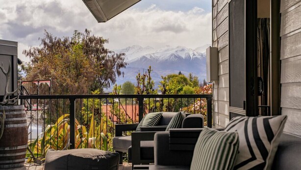 Un balcon avec coin salon extérieur, une vue sur les montagnes et une décoration rustique.