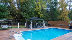 A wooden deck with a swimming pool, lounge chairs, and a gazebo. - Dink and Dip Catskills Poolside Oasis (Smallwood)