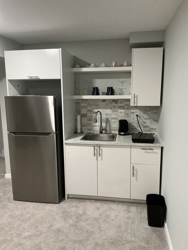 Fridge, stovetop, electric kettle, eco-friendly cleaning products - "Modern 2BR Suite with Private Entrance, Workspace, A/C & Parking in Sage Creek" (Winnipeg)