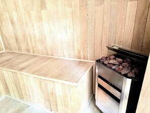 A kitchen with wooden cabinetry and a built-in grill. - Bolongo 3BR Your Exclusive Oceanfront Escape (Punta de Mita)