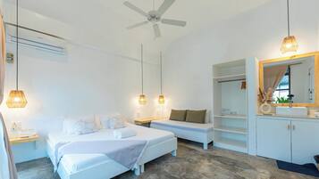 A modern bedroom with a bed, bedside tables, a ceiling fan, and a built-in wardrobe.