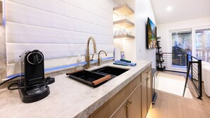 A modern kitchen with a built-in oven, a sink with a gold faucet, and a coffee machine. - Labor Day Sale - Limited Time Offer, Save up to 30% (Park City)