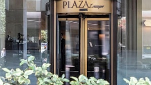 A building entrance with a sign reading 'PLAZA Lounge.' - NJV Athens Plaza (Athens)