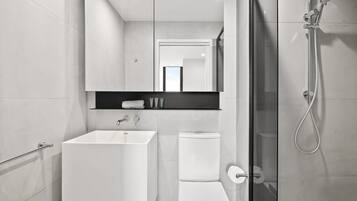 Shower, hair dryer, towels, shampoo