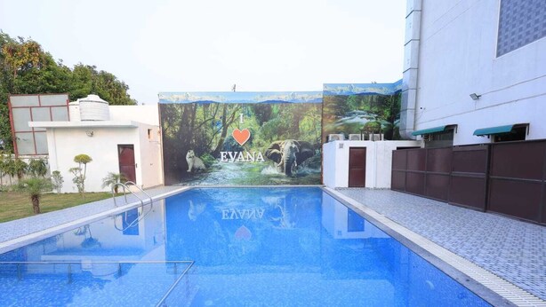 A swimming pool with a mural of an elephant and a heart, and the name 'EVANA' visible. - Evana Rajaji  (Ganga Bhogpur Malla)
