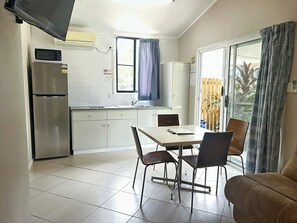 Basic Cabin, Patio | Private kitchen - Tropical Hibiscus Caravan Park (Wongaling Beach)