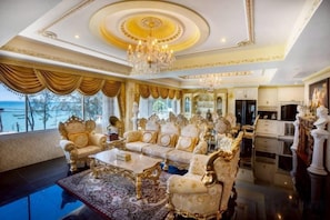 An opulent room with a grand chandelier, luxurious furniture, and a view of the sea. - Two Bedrooms Penthouse Seaview Rawai Beach Phuket (Phuket)
