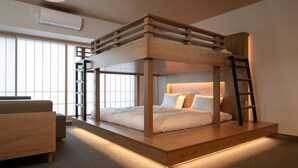 A bunk bed with a wooden frame, a bedside table, and a chair. - Mimaru Tokyo Kinshicho (Tokyo)