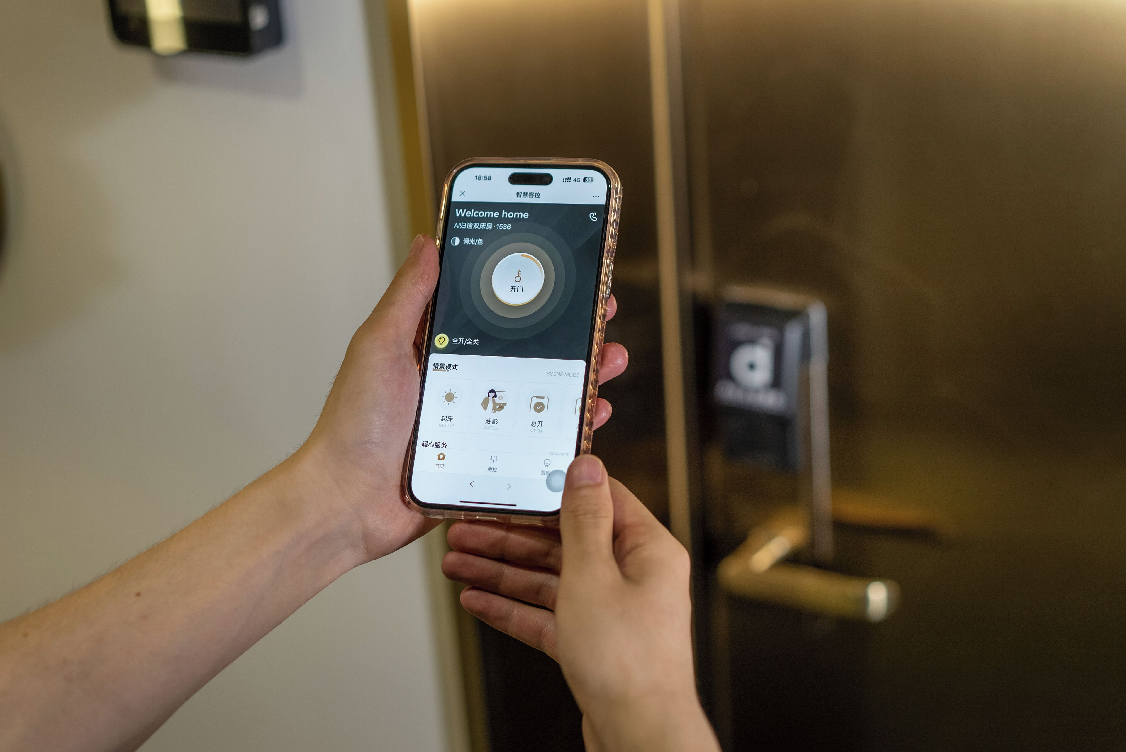 A person holding a smartphone with a hotel app interface, displaying options like 'Welcome home' and 'Scene Mode' with various settings.