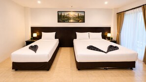 A hotel room with two beds, a large painting on the wall, and a view of the outdoors through the window. - Charming Guest Room in Central Pa Tong, Thailand (Pa Tong)