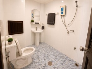 A bathroom with a toilet, sink, and shower. - Charming Guest Room in Central Pa Tong, Thailand (Pa Tong)