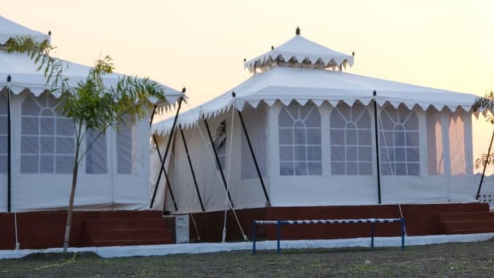 A Rajwadi Tent with a traditional design, featuring a central window and a peaked roof.