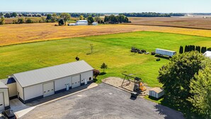 A large industrial building with a gravel driveway and a green field in the background. - 1 Mi to Main St! Family Farmhouse in West Unity (West Unity)