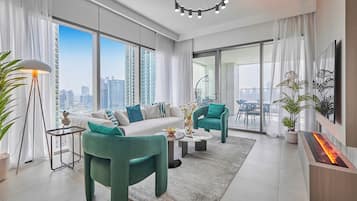 Premium Apartment, City View | Living room | 65-inch Smart TV with cable channels