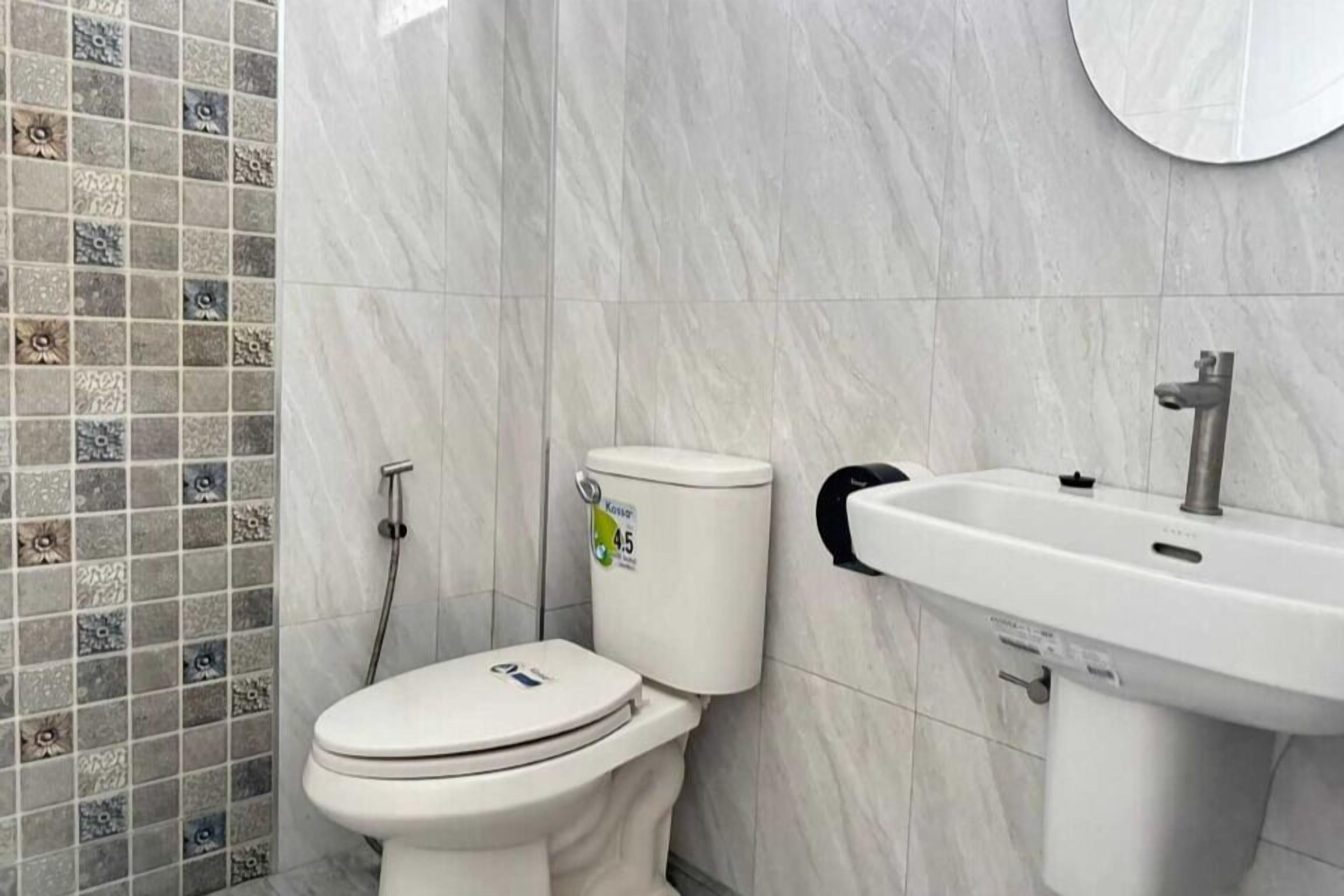 A bathroom with a toilet, a sink, and a shower.