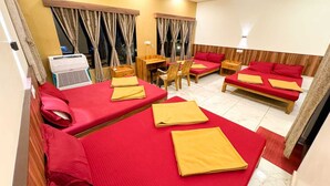 A hotel room with two single beds, a desk, chairs, and a small table. - Dandeli Inn Resort  (Dandeli)