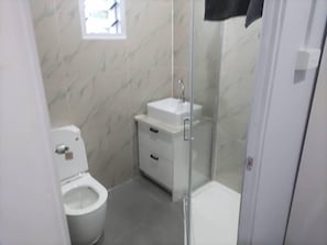 Economy Studio Suite, Balcony, City View | Bathroom | Slippers, towels, soap, shampoo