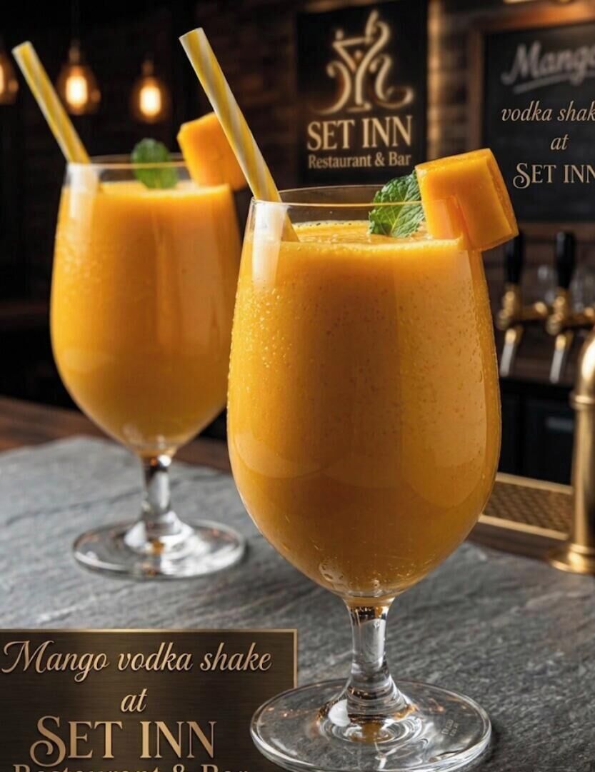Two glasses of mango vodka shake at a restaurant.