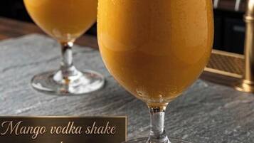 Two glasses of mango vodka shake at a restaurant.