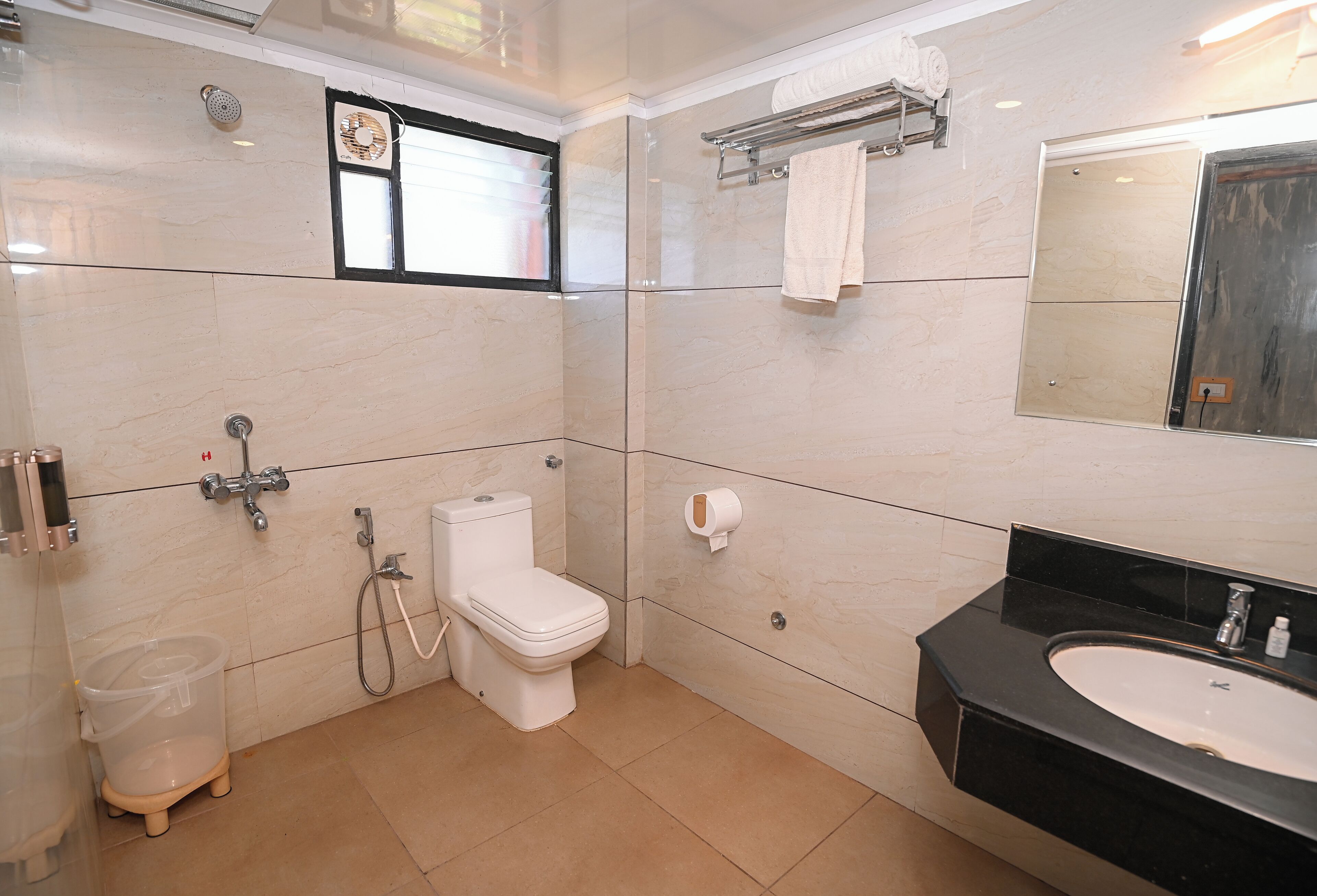 A modern bathroom with a toilet, bidet, and sink.