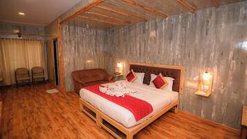 Une chambre à coucher avec un lit en bois, deux lampes de chevet, une tête de lit en bois et une chaise.