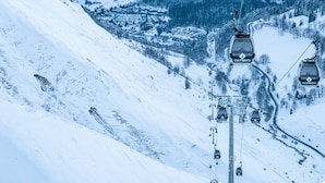 A cable car system with cabins labeled "Calypso" in a snowy mountainous area.