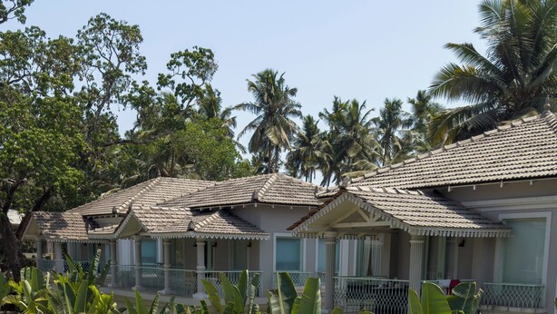 A resort with multiple villas, a swimming pool, and lush tropical vegetation. - Love Story by Purple Door Villas (Siolim)
