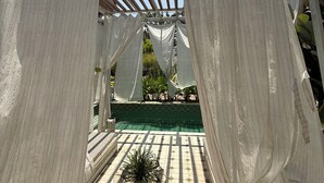 A covered outdoor area with a tiled floor and a potted plant. - Love Story by Purple Door Villas (Siolim)