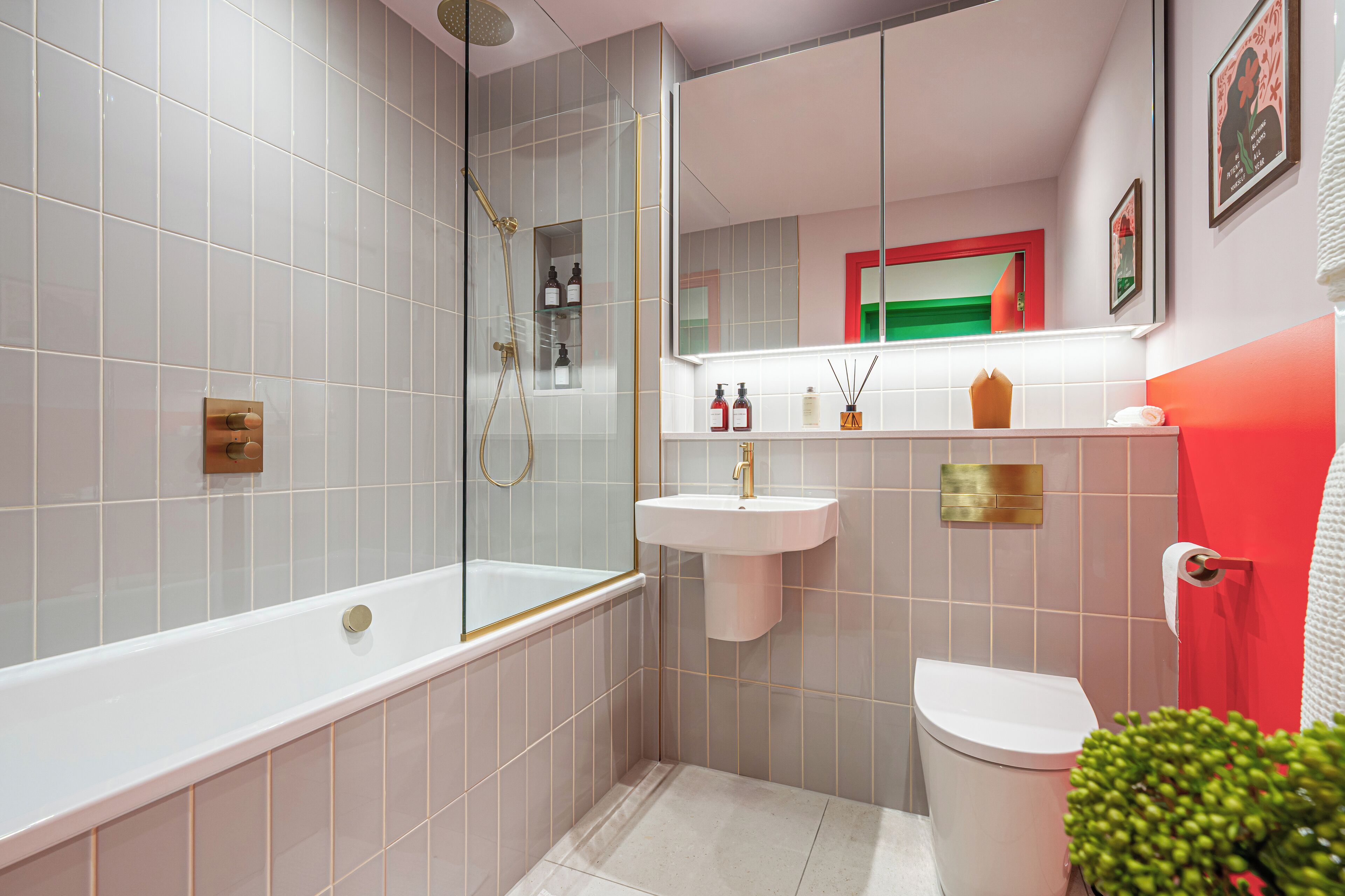 A modern bathroom with a bathtub, sink, and toilet.