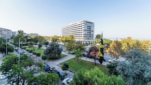 A multi-story hotel with a modern design, surrounded by a well-maintained garden and parked cars. - City Moon by halu (Thessaloniki)