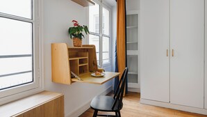 A room with a wooden desk, a chair, a potted plant, and a wardrobe. - Paris Center Rivoli residence (Paris)