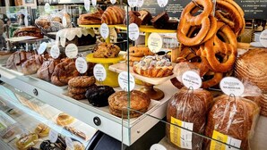 A bakery display with various baked goods like pretzels, cookies, and bread. - Bluebird Day - Summit Sanctuary: Perfect for a romantic getaway. (Bend)