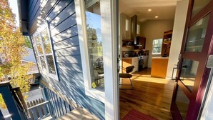 A modern kitchen with wooden cabinets and a central island. - Bluebird Day - Summit Sanctuary: Perfect for a romantic getaway. (Bend)