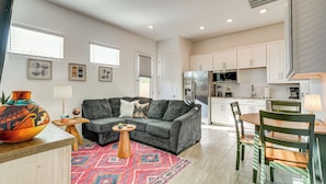 A modern kitchen with white cabinets, a stainless steel refrigerator, and a microwave. - Mtn Views & Private Hot Tub: Buckeye Getaway (Buckeye)